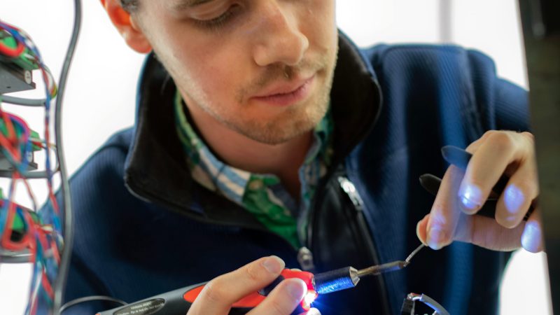 student soldering a component