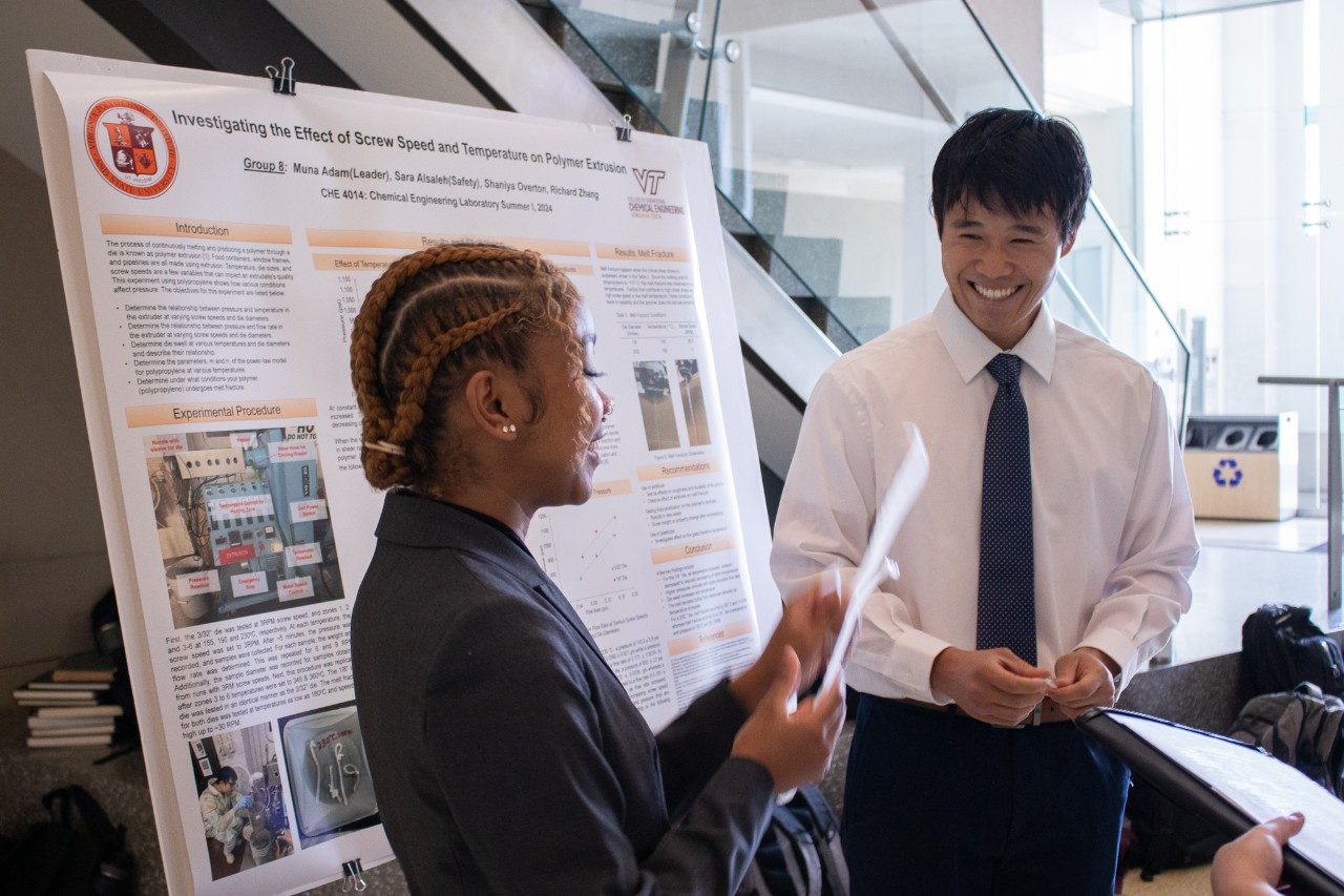 Two chemical engineering students presenting their research.